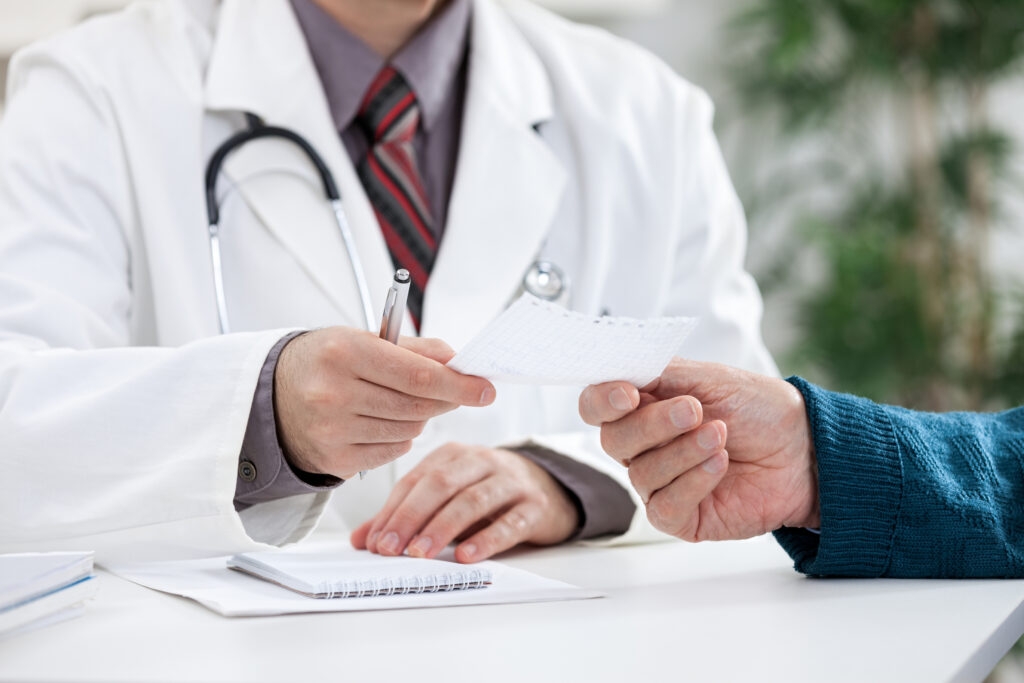 Doctor Giving A Prescription To His Patient